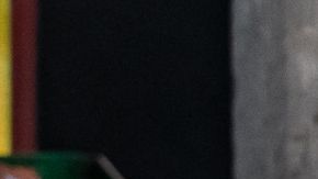 Women with a red sombrero and Mexico flag standing in front of a red lowrider