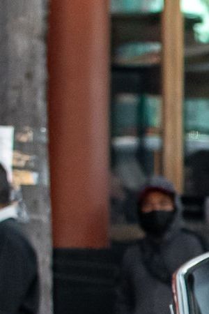 Women with a red sombrero and Mexico flag standing in front of a red lowrider