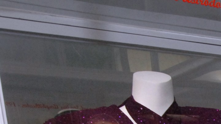 In this June 24, 2011 photo, Abraham Quintanilla, the father of late singer Selena, poses for pictures in front of the outfit that his daughter wore in her last concert in Corpus Christi, Texas. (AP Photo/Paul Iverson photo)