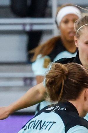 Orlando Pride forward Marta Marta, right, brings the ball down the pitch against NJ/NY Gotham FC defender Emily Sonnett (6), midfielder Josefine Hasbo, center, and defender Kayla Duran (19) during the second half of an NWSL women's semifinal soccer match, Sunday, Nov. 16, 2025, in Orlando, Fla. (AP Photo/Kevin Kolczynski)
