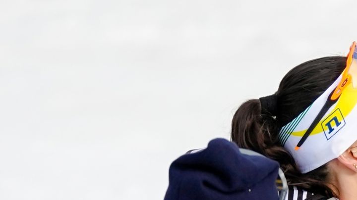 Regina Martinez Lorenzo, of Mexico, center, the last athlete to cross the finish line, is embraced by Bruna Moura, of Brazil, center left, and Jessie Diggins, of the United States, while silver medalist Ebba Andersson, of Sweden, left, and gold medalist Frida Karlsson, of Sweden, right, look on, at the end of the cross country skiing women's 10km interval start free at the 2026 Winter Olympics, in Tesero, Italy, Thursday, Feb. 12, 2026. (AP Photo/Matthias Schrader)