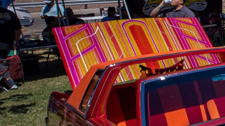 Title: Hispanic Heritage Lowriders Image ID: 24289445719586 Article: A family looks at vintage cars during a lowrider exhibition for the 20th anniversary of Lincoln Park in El Paso, Texas, Sunday, Sept. 22, 2024. (AP Photo/Andrés Leighton)