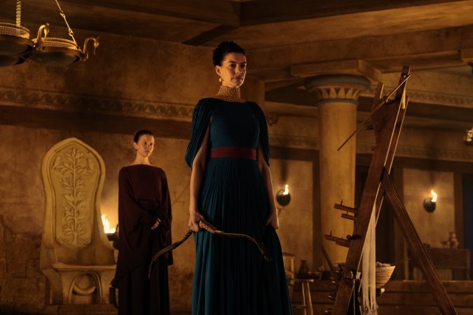L to R: Mia Goth is Melantho and Anne Hathaway is Penelope in THE ODYSSEY, written, produced, and directed by Christopher Nolan.